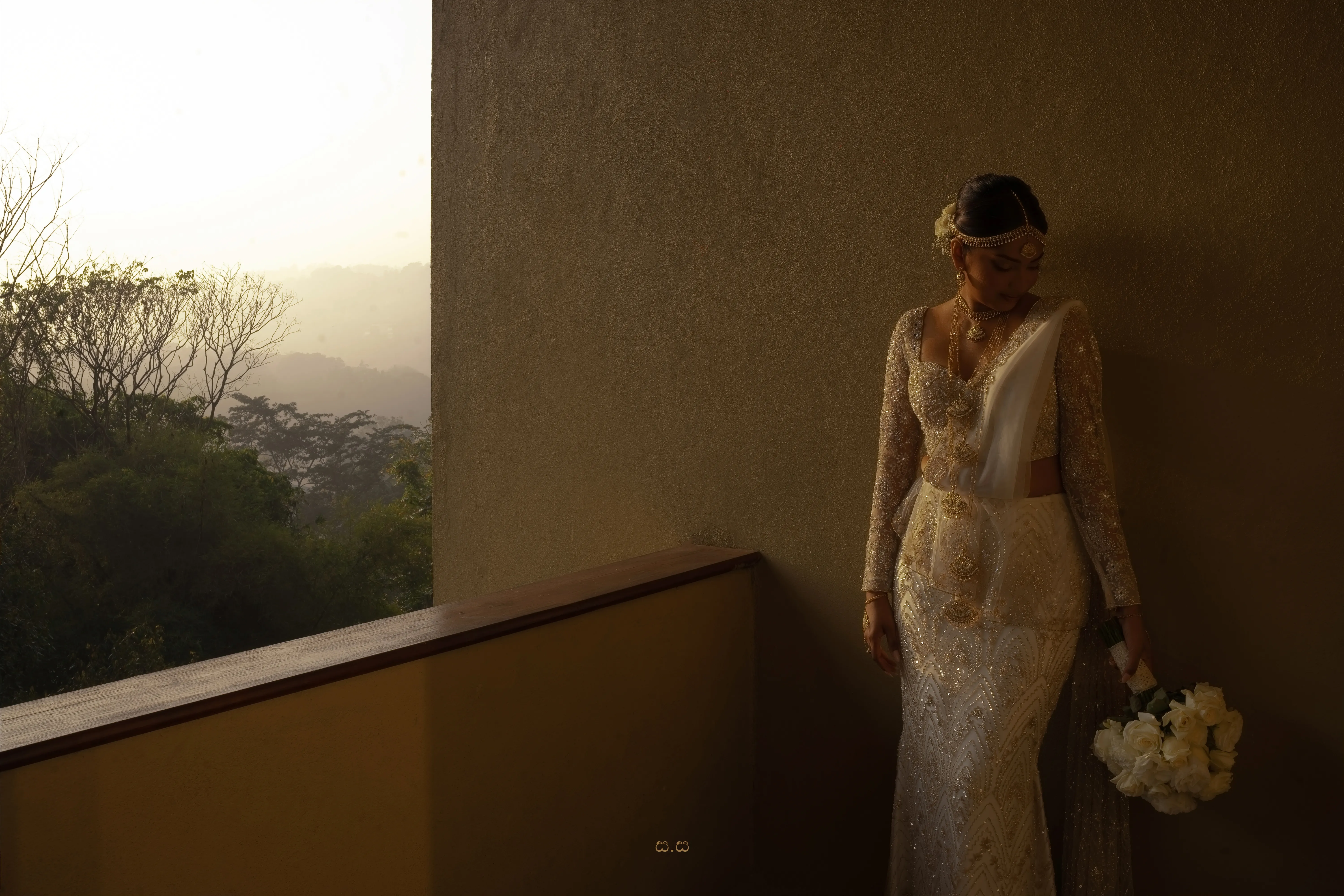 Sanduni holds her bouquet in warm morning light overlooking the hills.