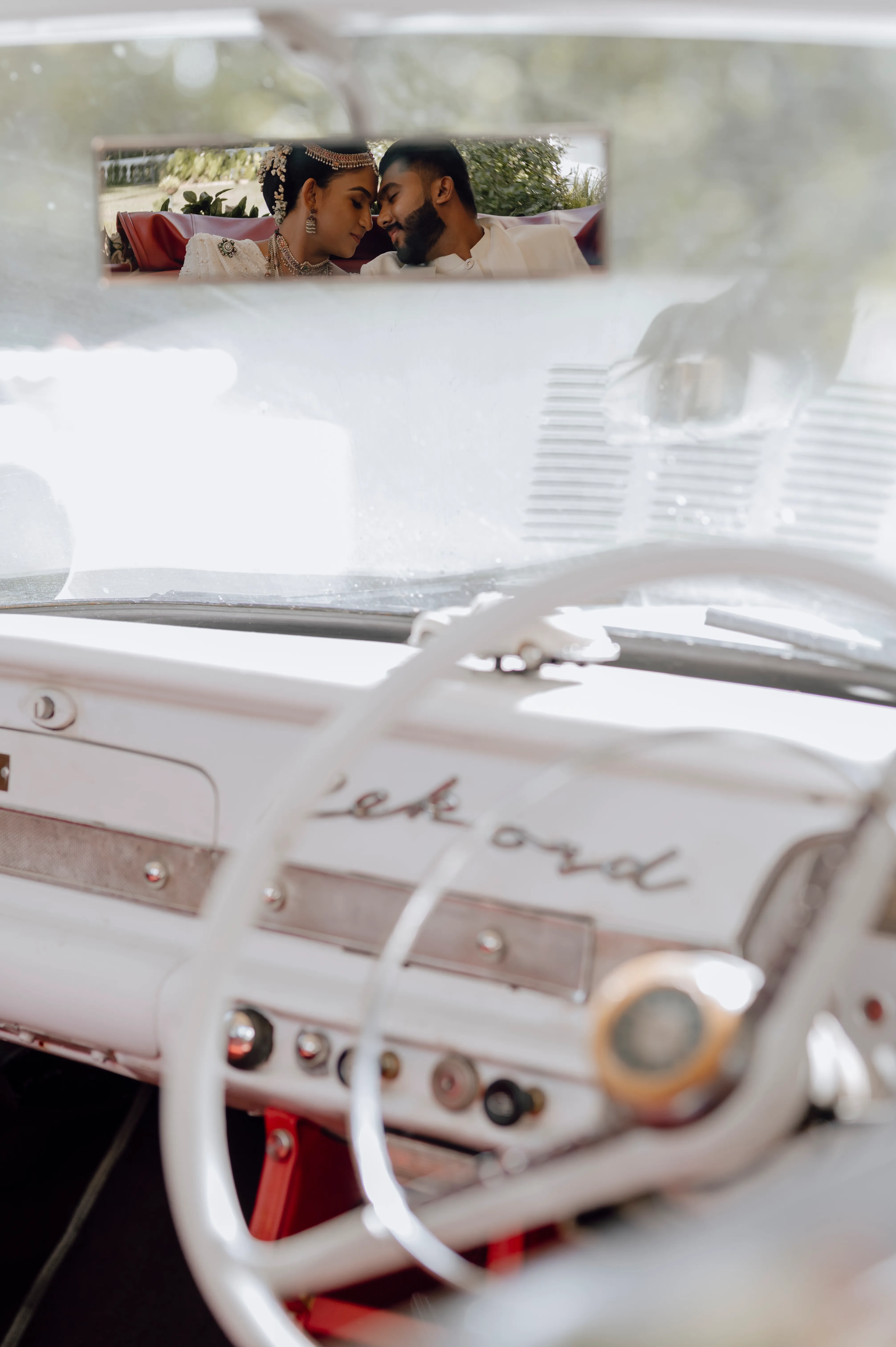 The chrome steering wheel and Ford emblem recall the couple’s classic arrival.