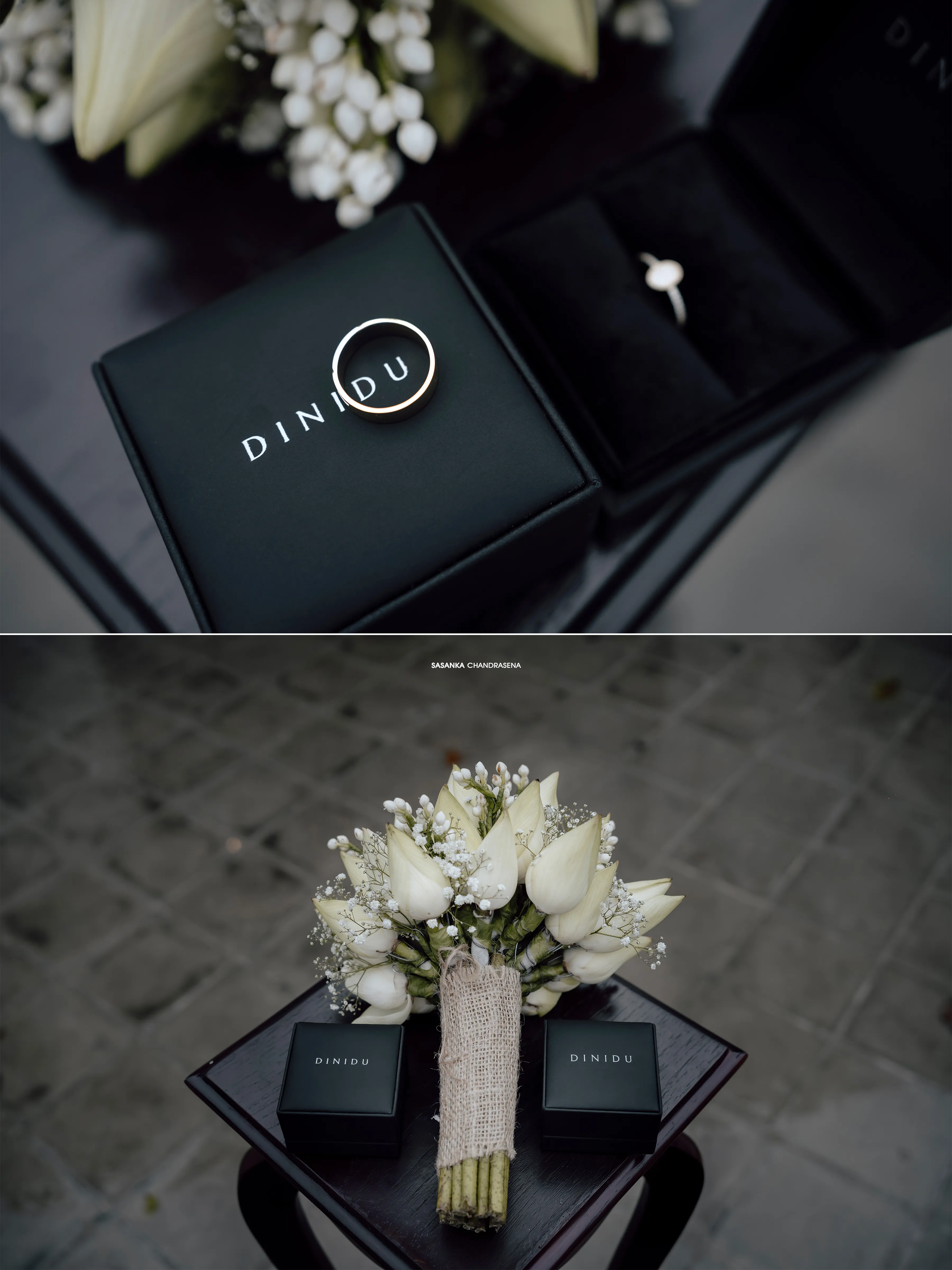 Two ring boxes rest beside an ivory bouquet on a dark table.