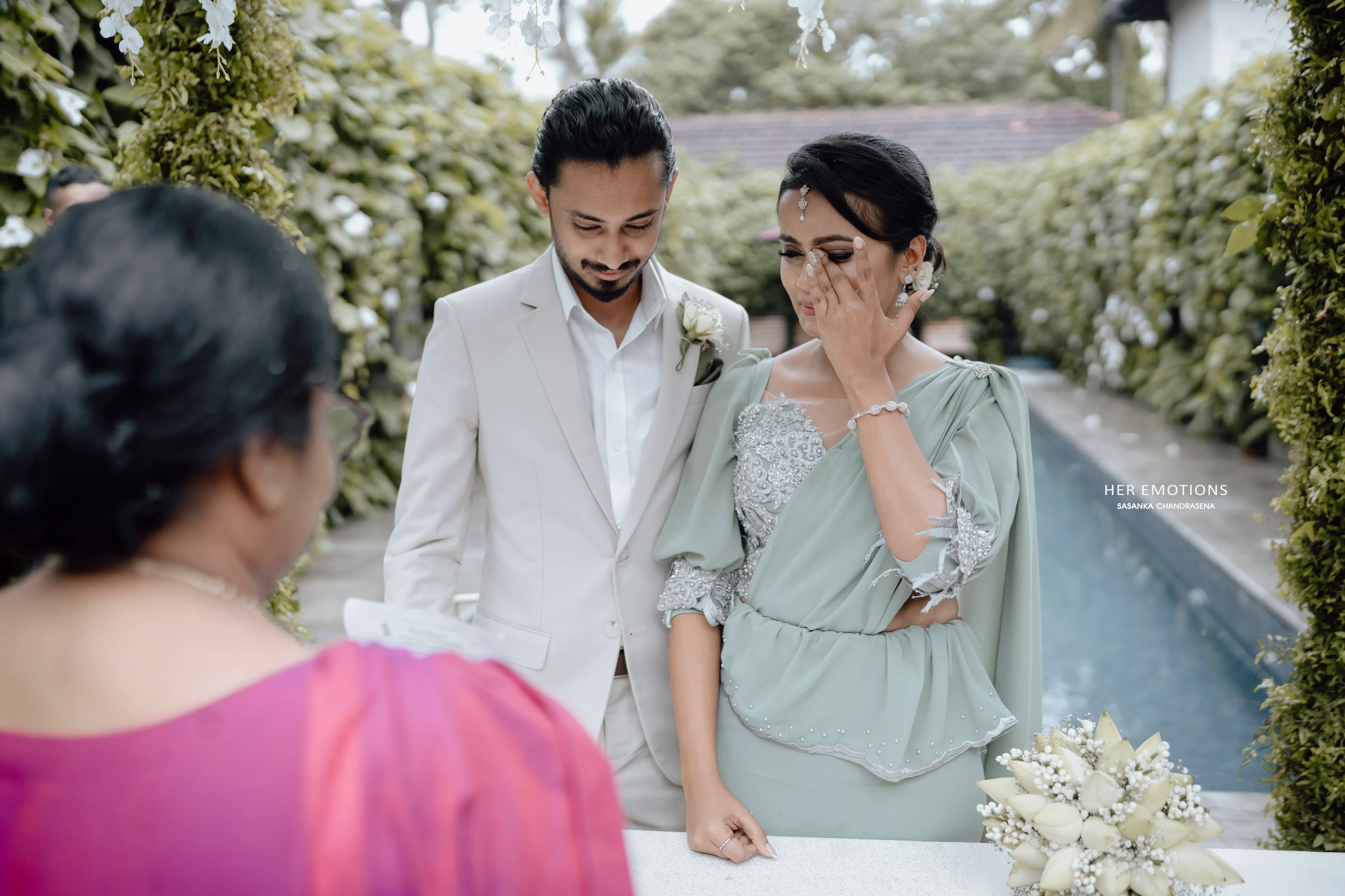 An emotional family moment unfolds beside the pool after the ceremony.