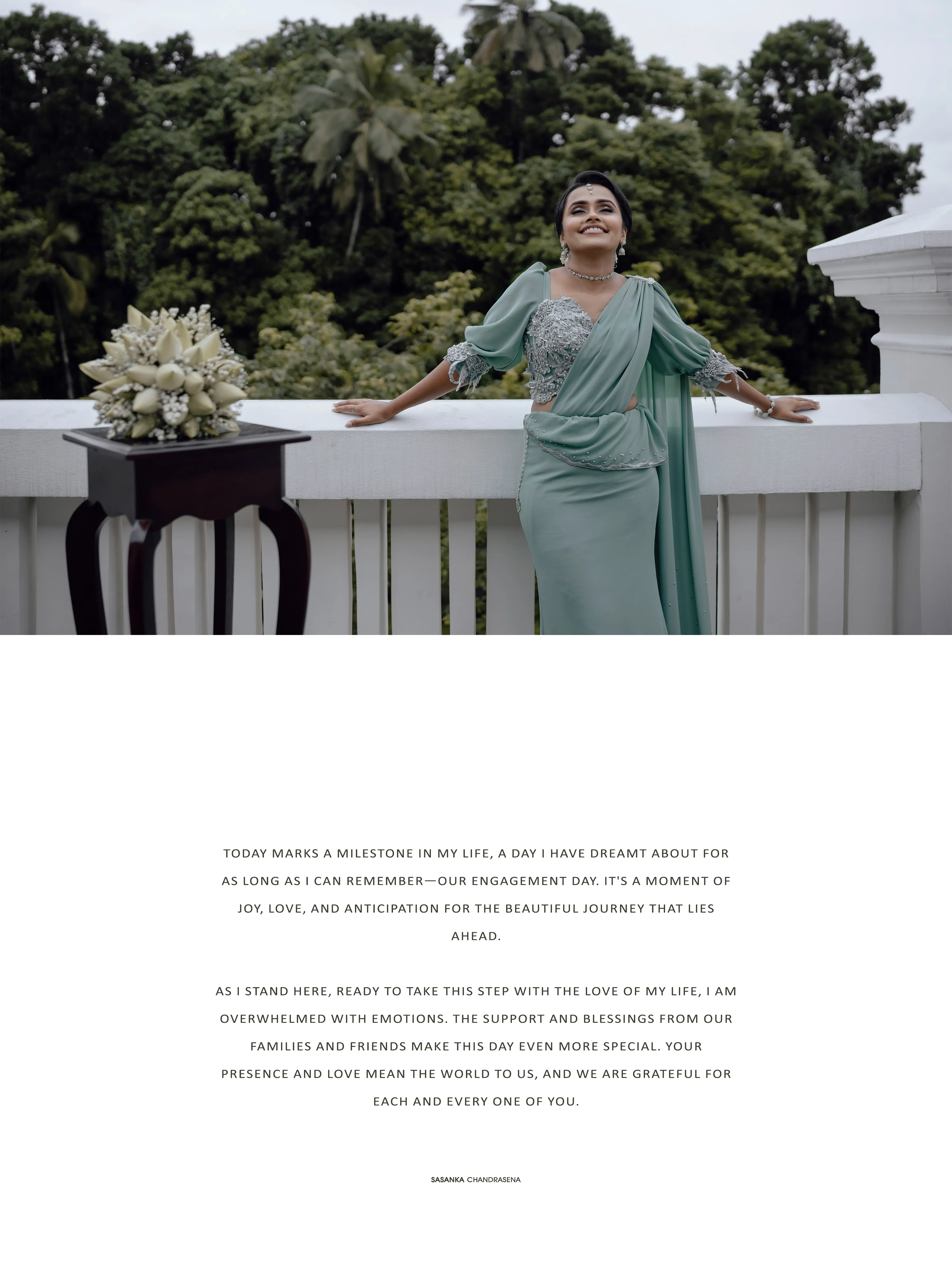 The bride-to-be poses beside her bouquet on the bright white veranda.