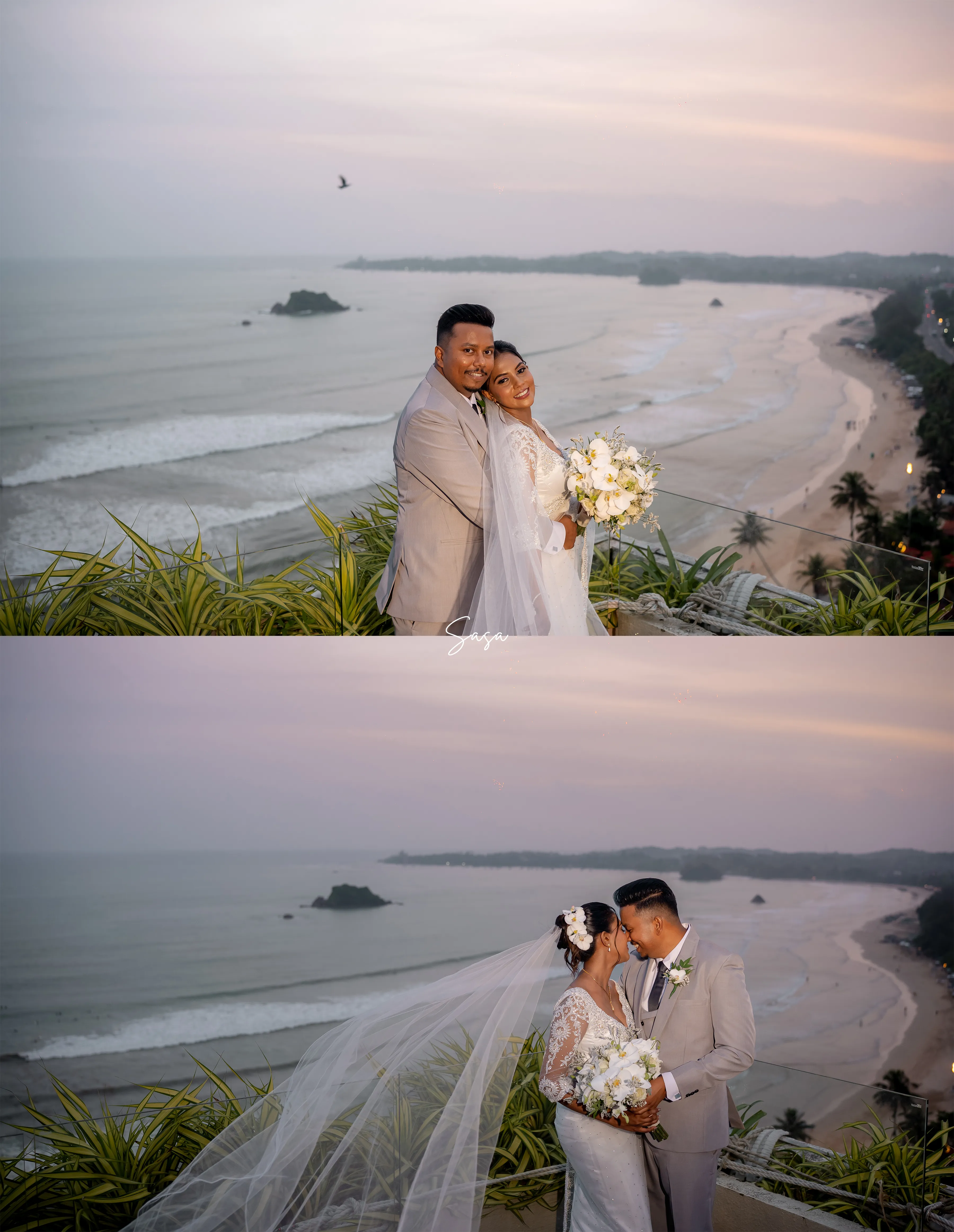 The couple stands together on a high terrace overlooking the curved coastline.