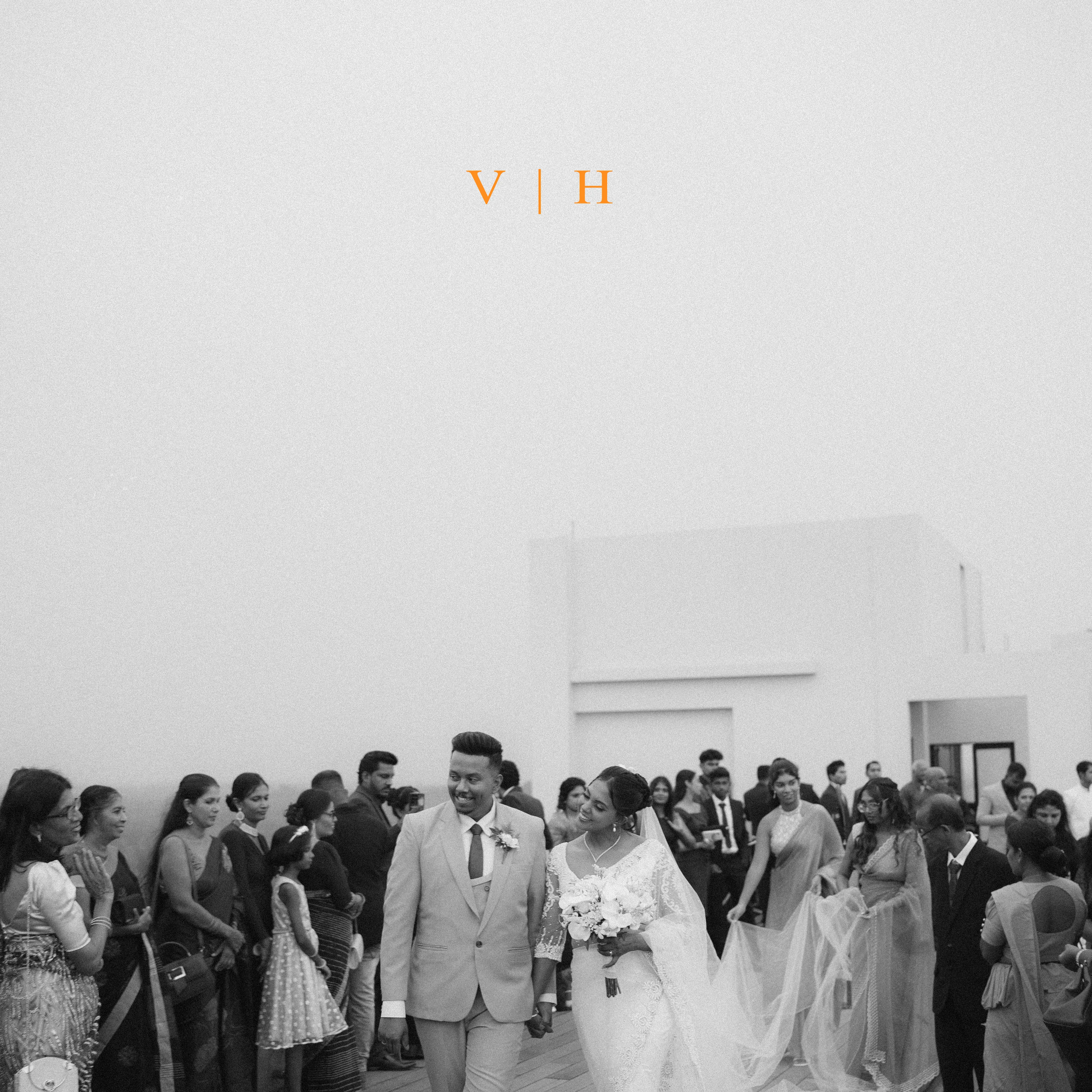 Harindi and Venura walk through a joyful gathering of family and friends.