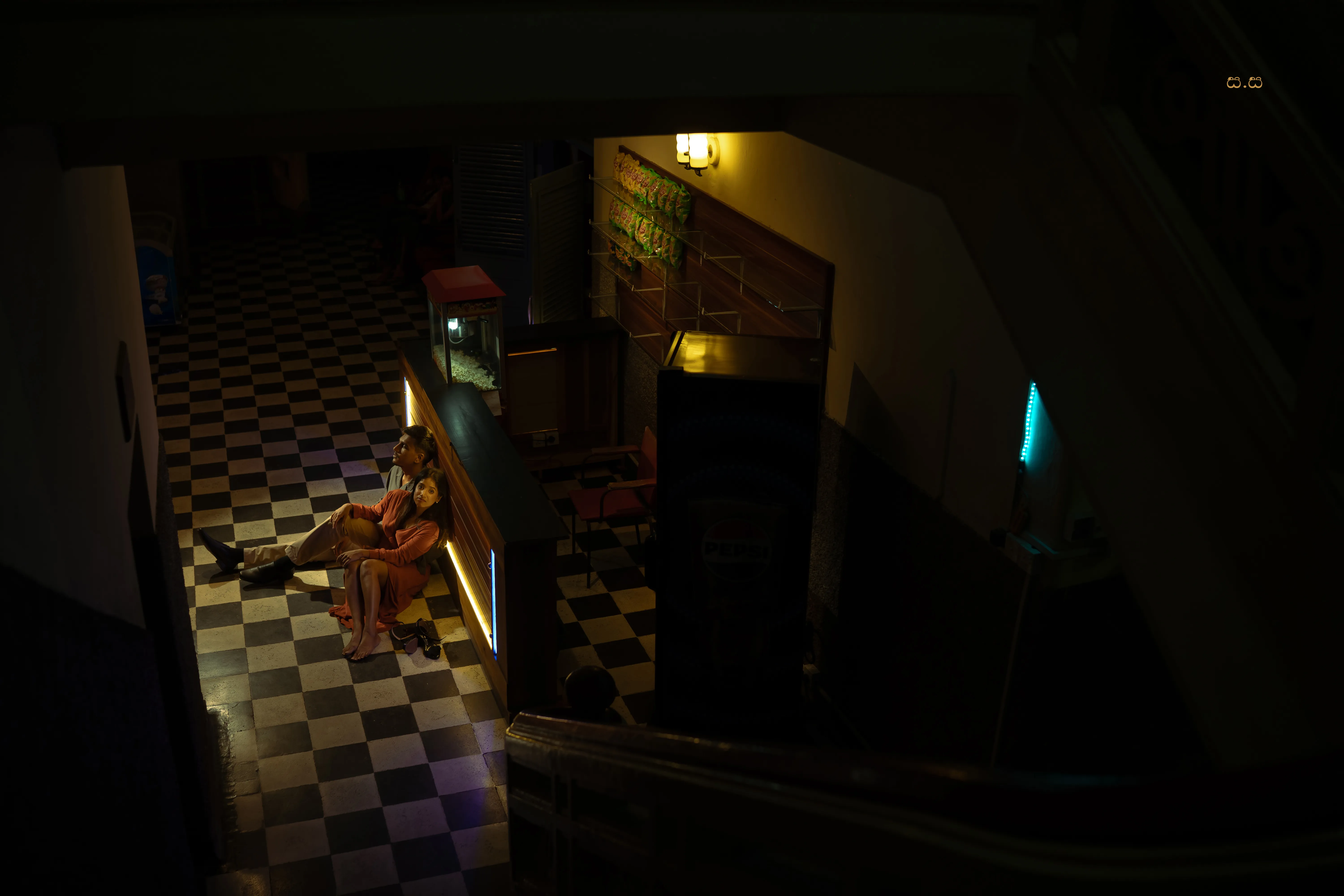 An overhead view looks down through the cinema’s patterned lobby.