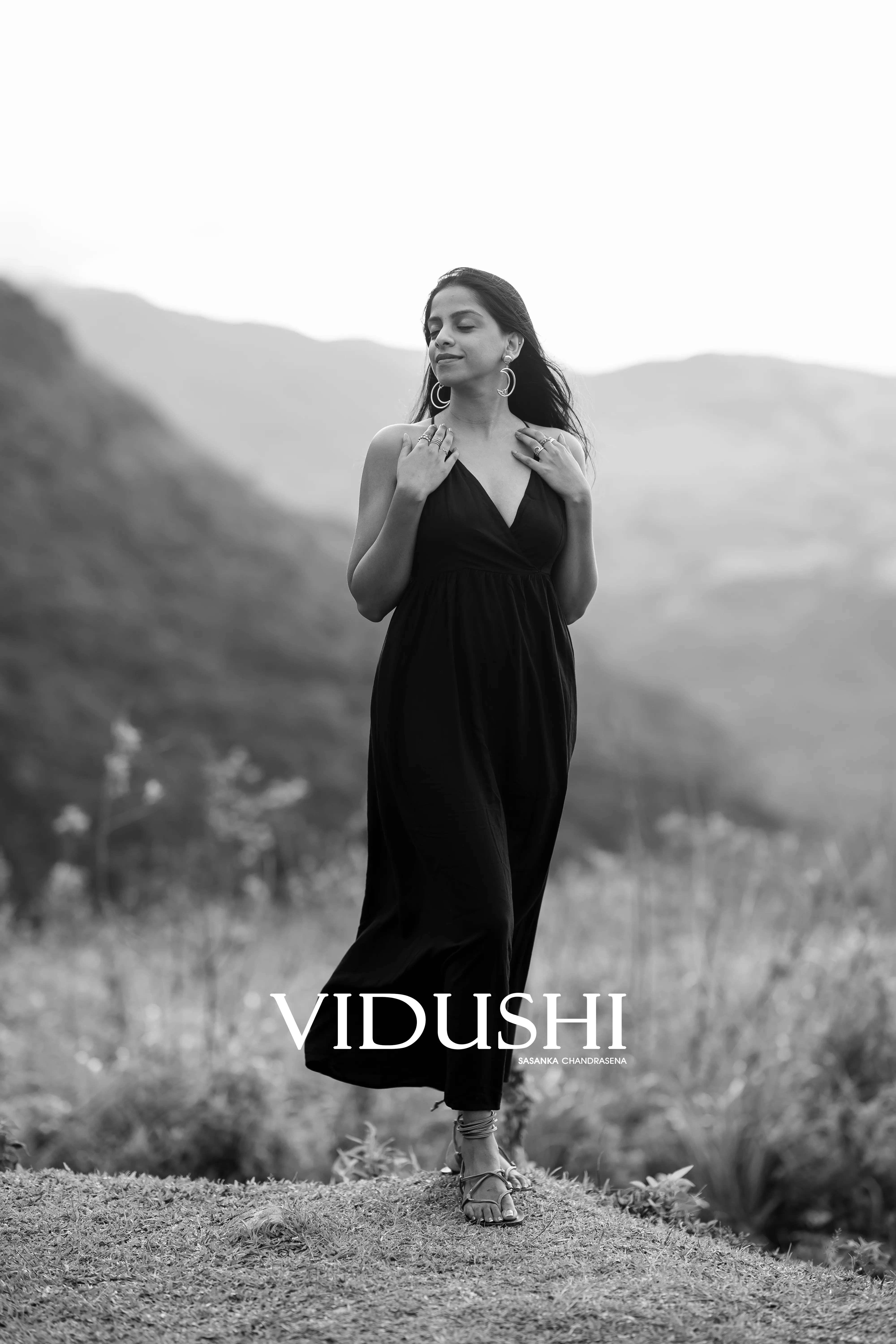 A black-and-white solo portrait frames Vidushi against distant ridgelines.