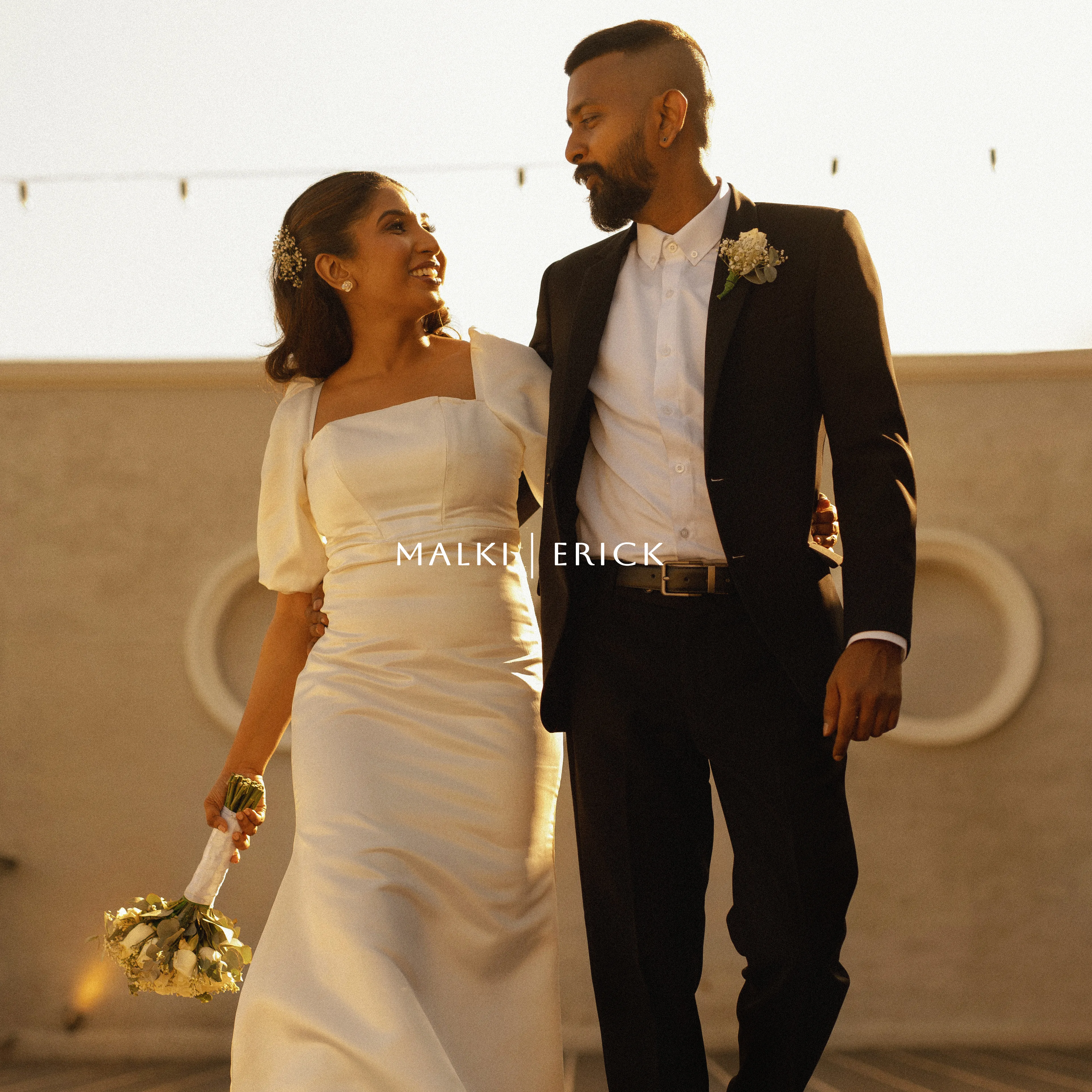Malki and Erik walk together through warm late-afternoon light.