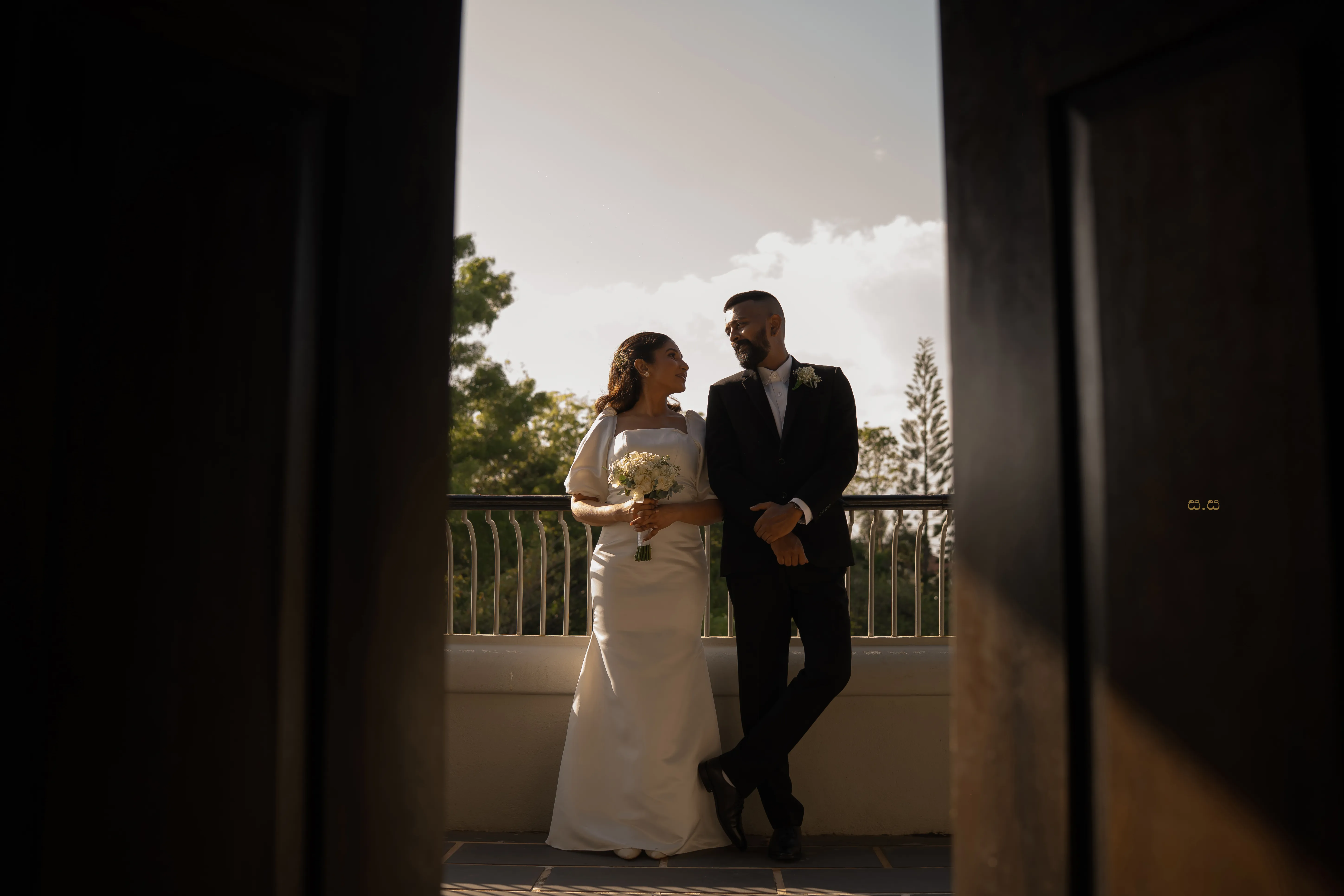 Malki and Erik step through a shadowed doorway toward the celebration.