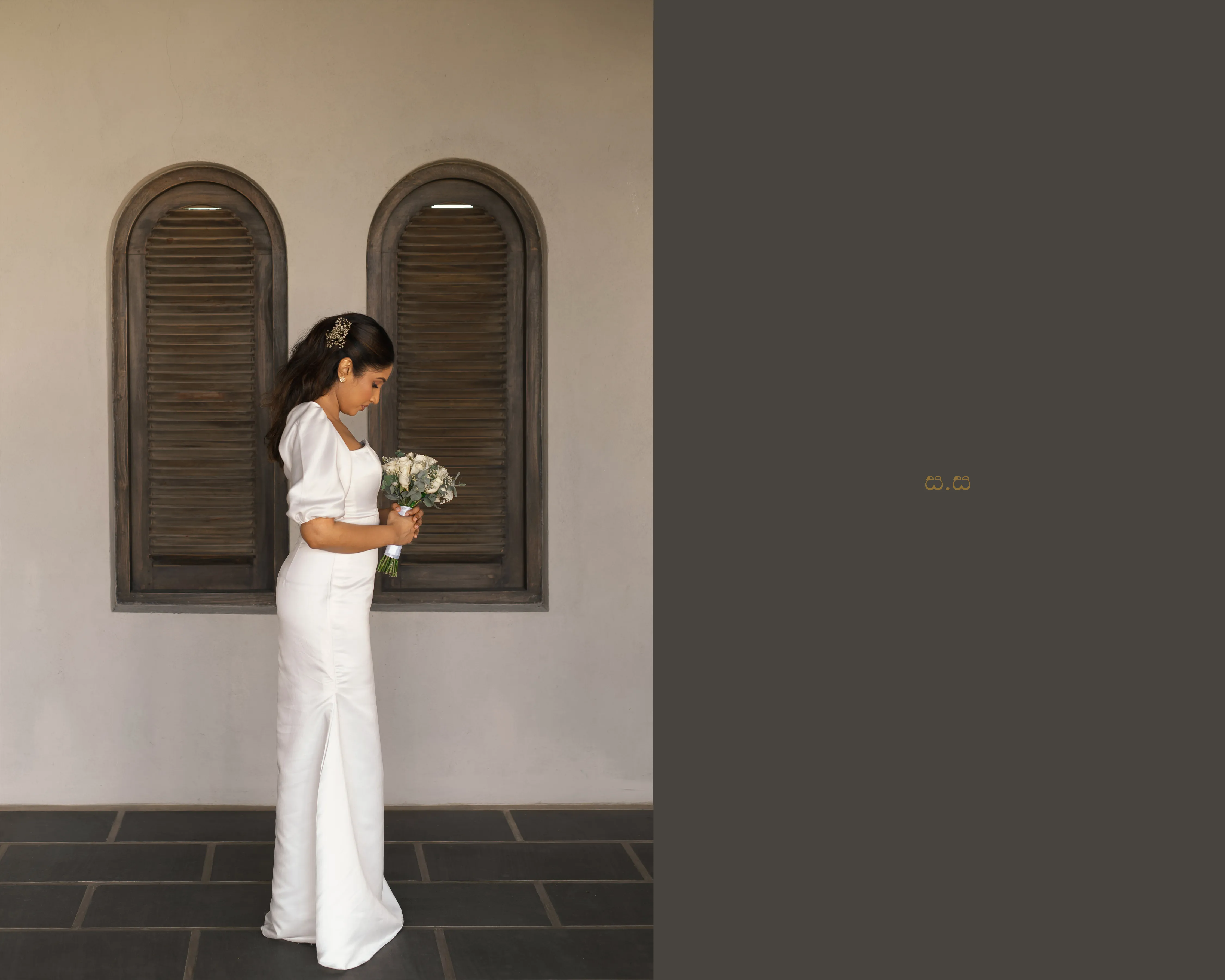 Malki stands in profile with her bouquet against dark wooden shutters.