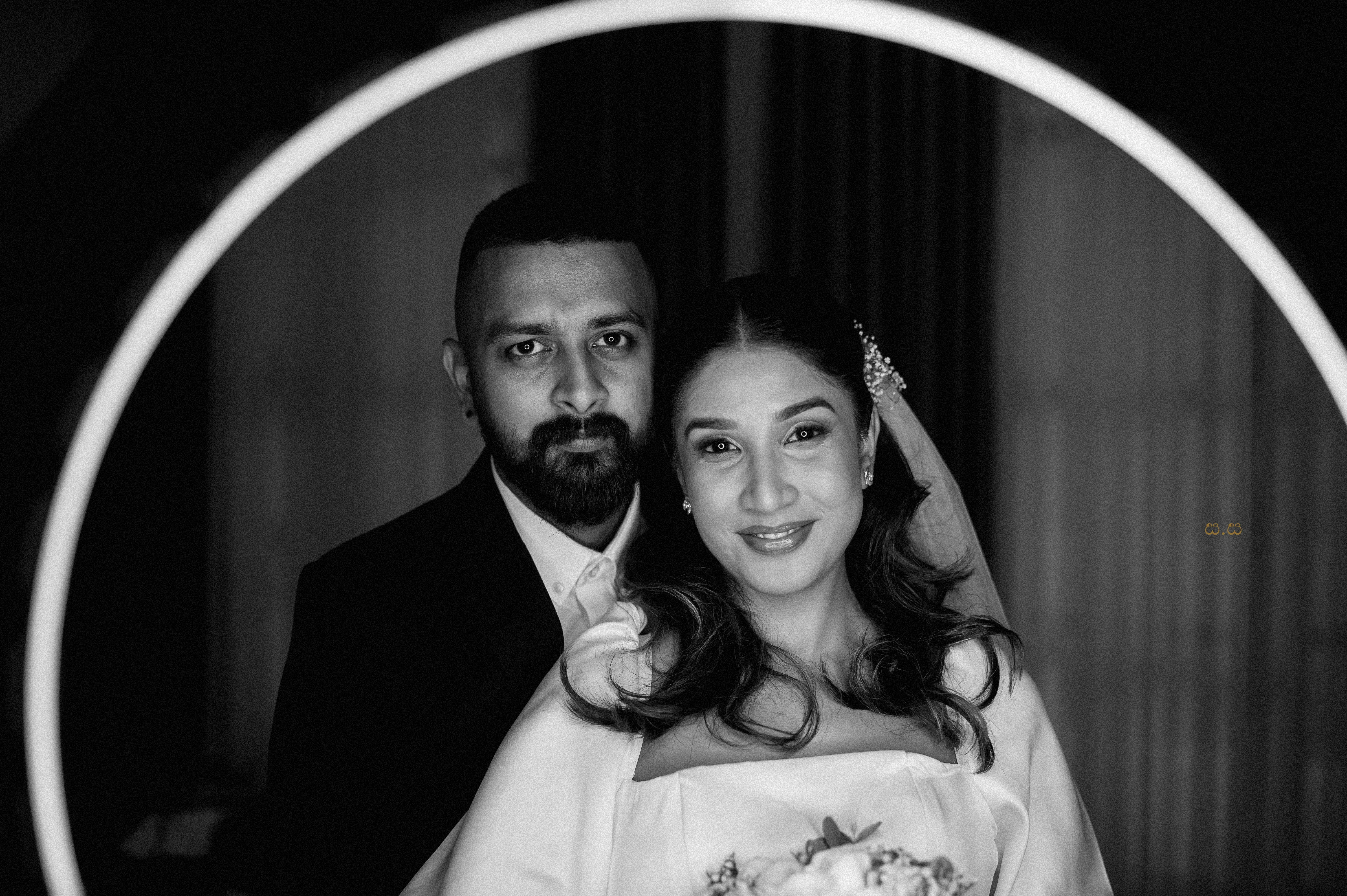 Malki and Erik face the camera within a bold circular frame.