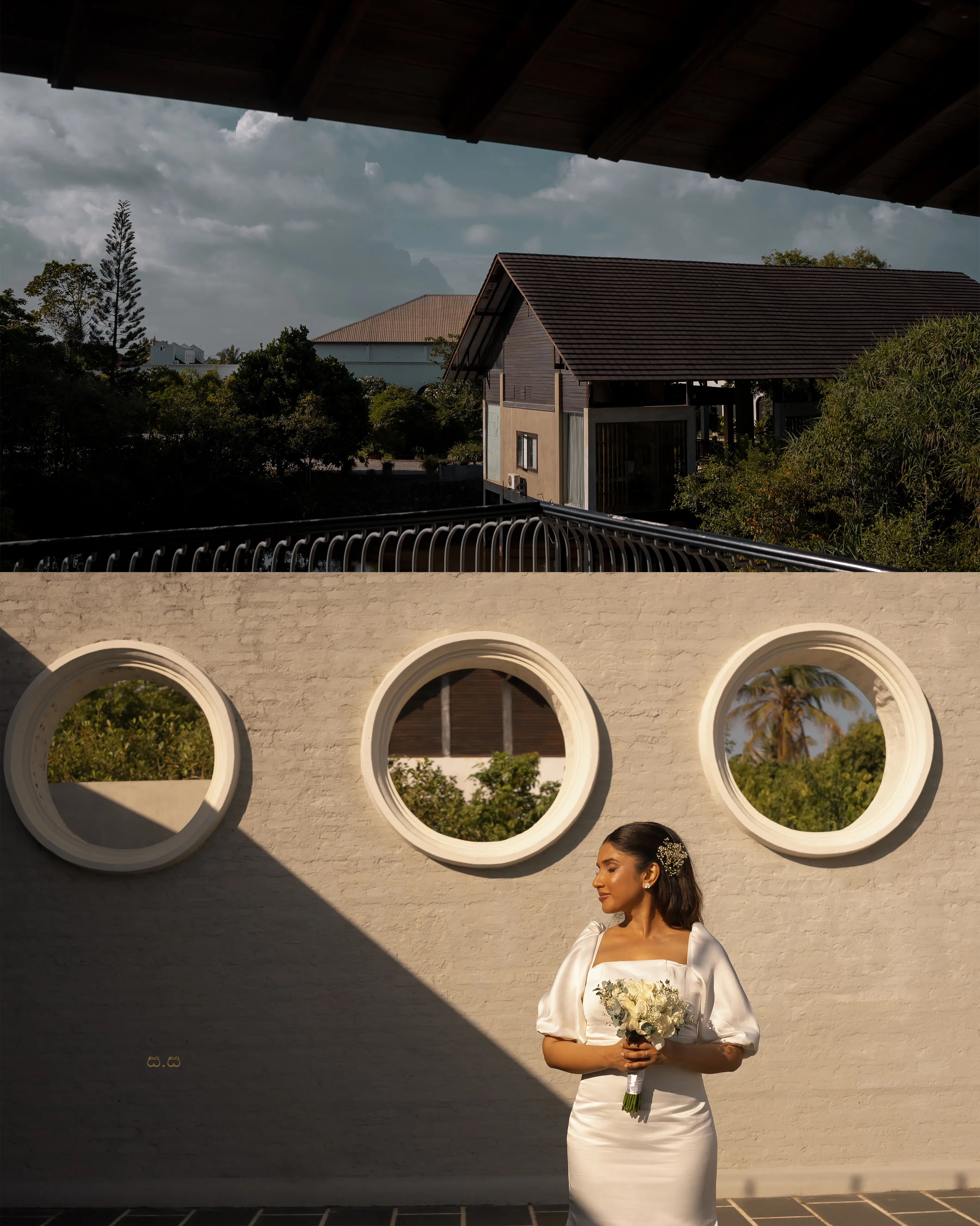 The bride stands alone in warm light below three circular openings.