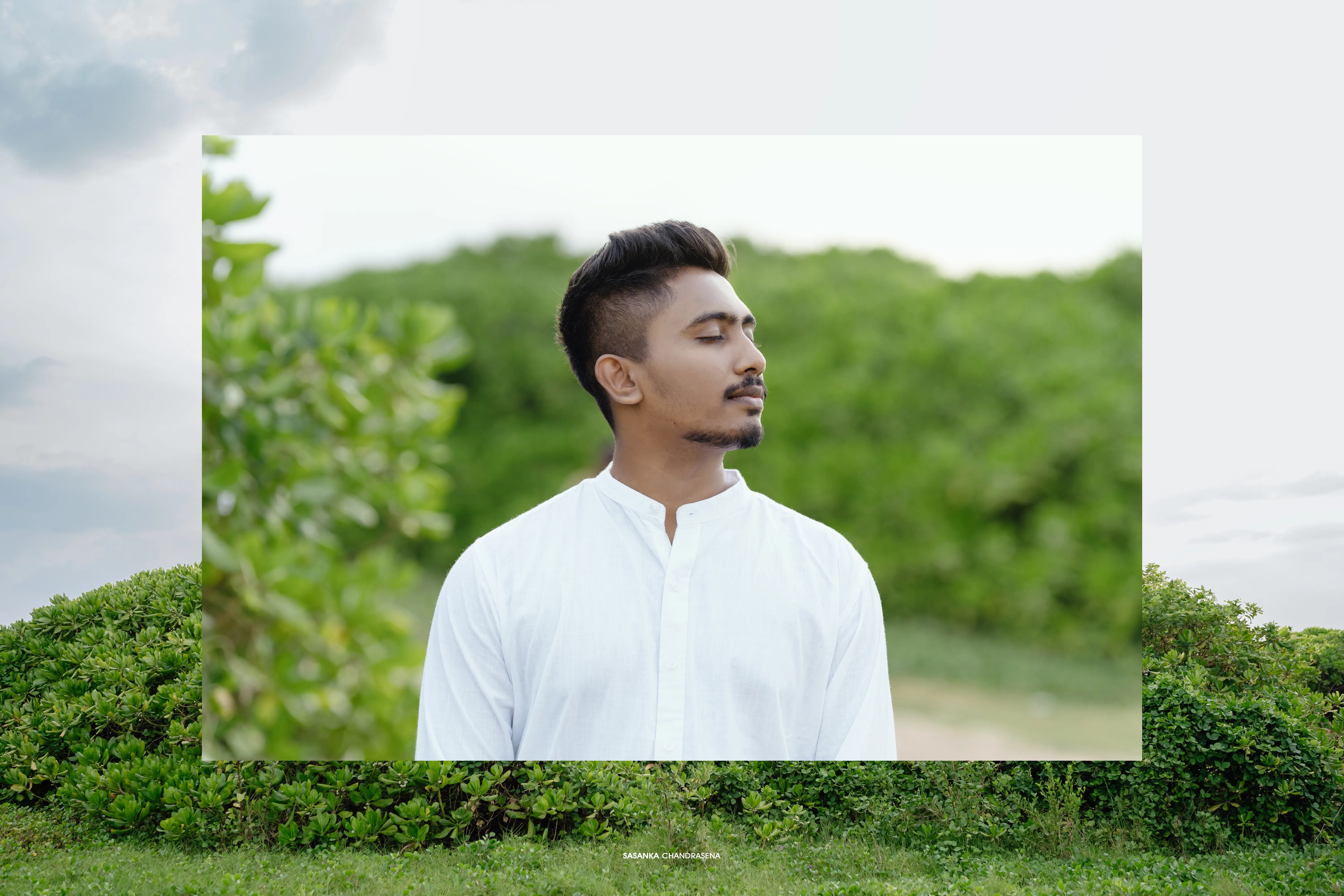 Sanka stands alone in white against dense tropical greenery.