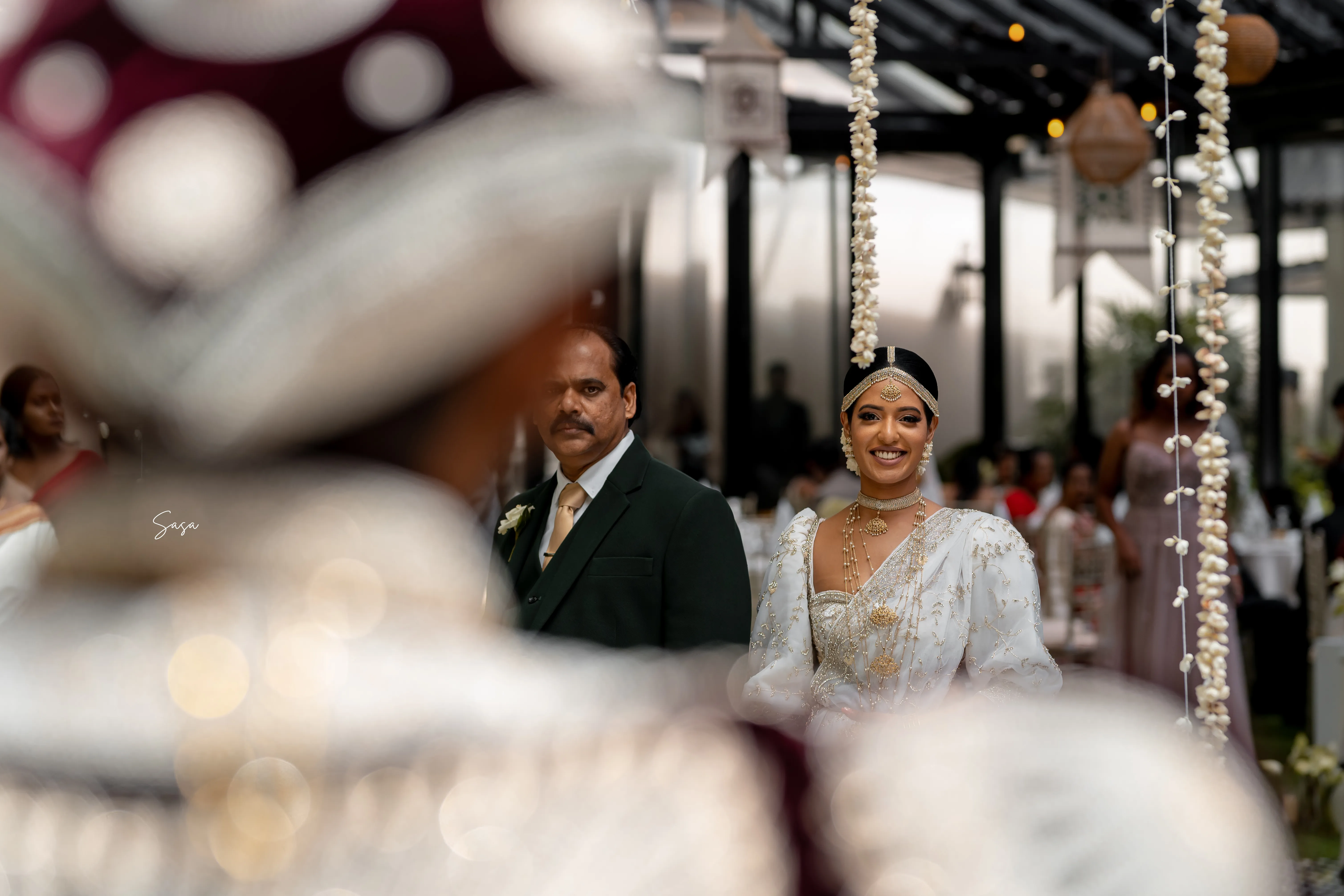 Sachini walks beside a family member toward the wedding ceremony.