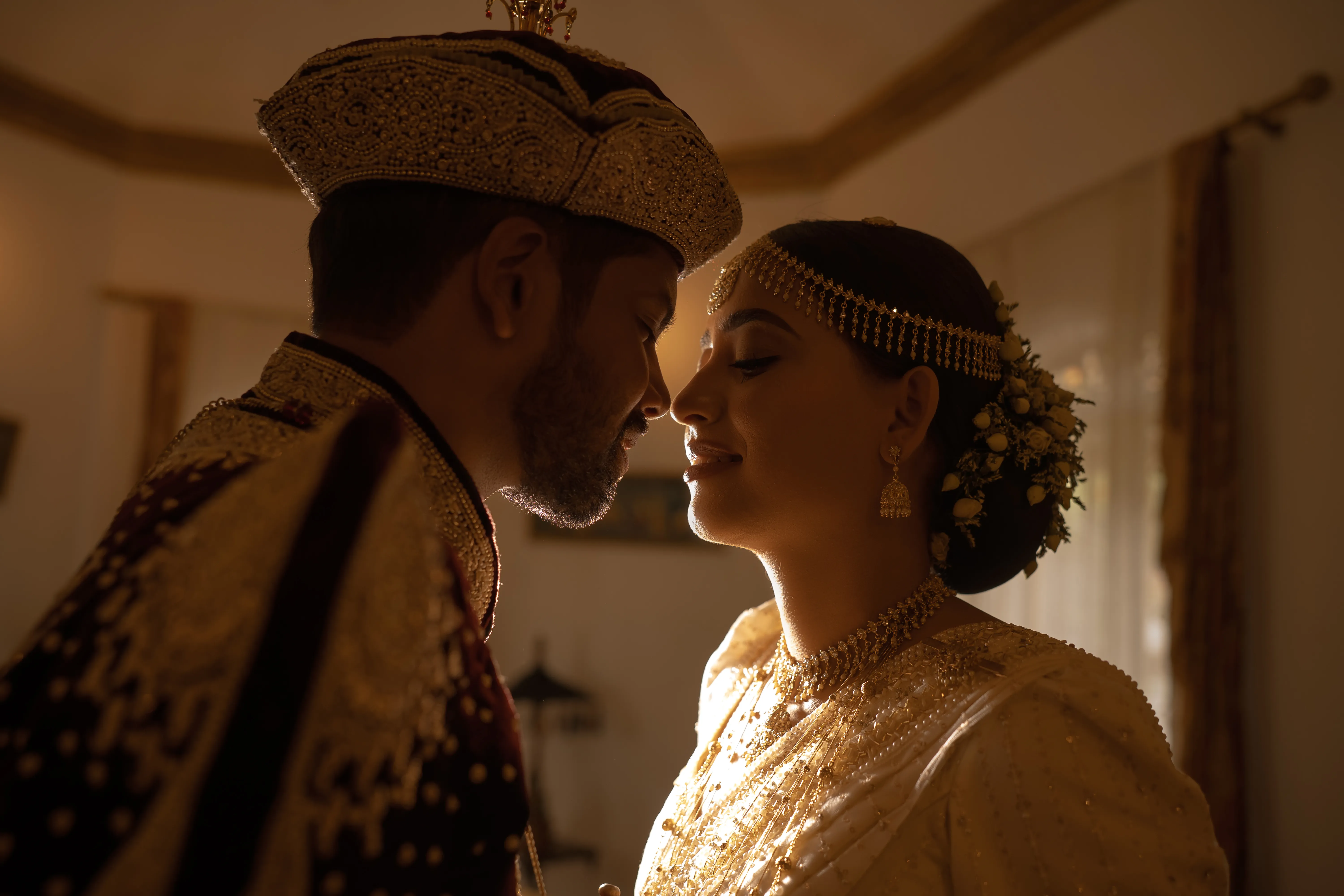 A Sri Lankan bride and groom in a warm, close wedding portrait